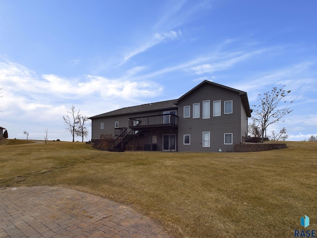 rear view of house with a yard and a deck