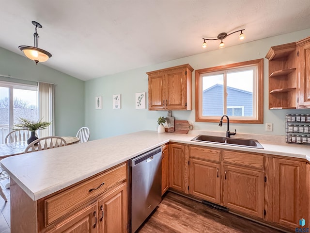 kitchen with dishwasher, sink, dark hardwood / wood-style flooring, kitchen peninsula, and pendant lighting