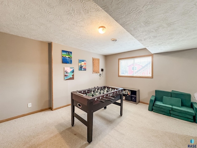 game room with carpet and a textured ceiling