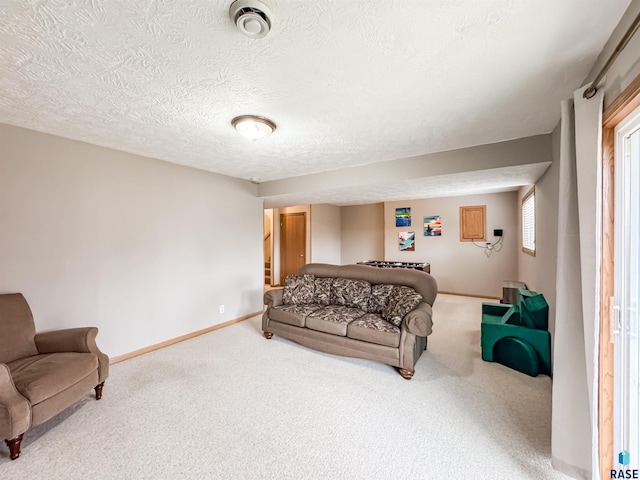 carpeted living room with a textured ceiling