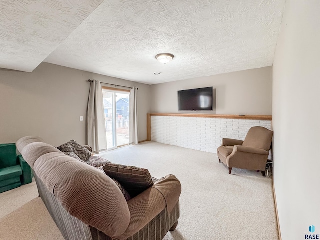 carpeted living room featuring a textured ceiling