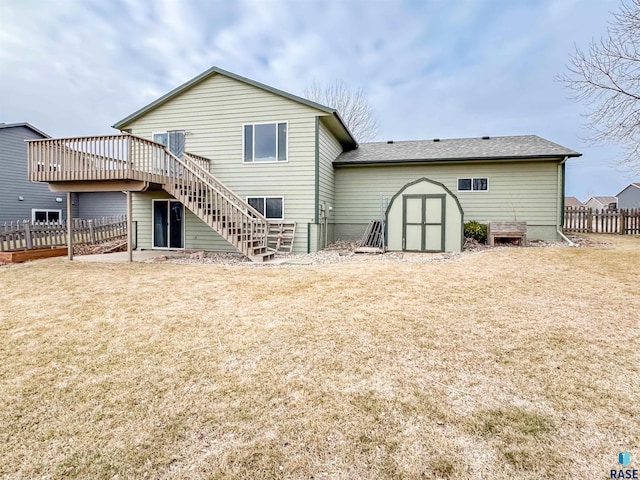 back of property with a shed and a deck