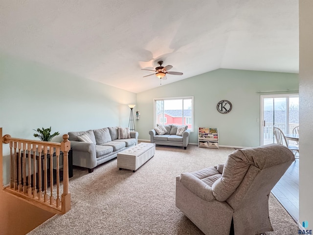 carpeted living room featuring vaulted ceiling, a wealth of natural light, and ceiling fan