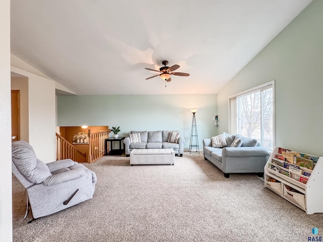 carpeted living room with ceiling fan and lofted ceiling