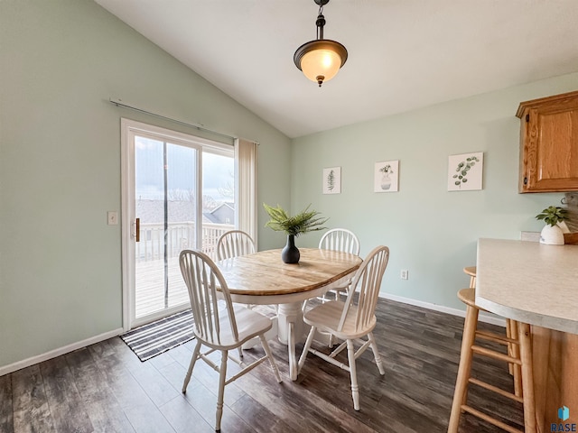 dining area with lofted ceiling and dark hardwood / wood-style floors