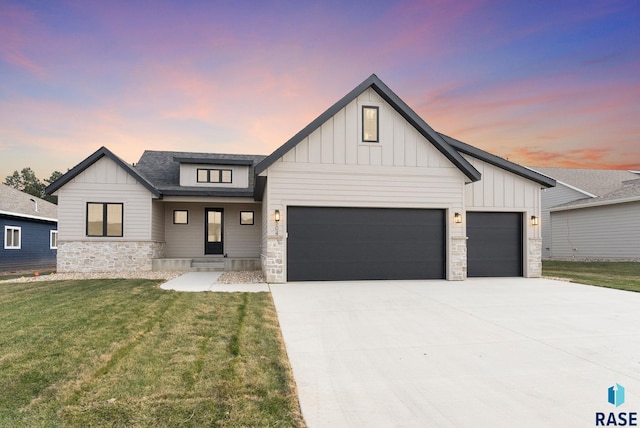 modern farmhouse style home with a yard and a garage