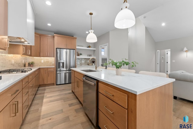 kitchen with backsplash, a large island with sink, hanging light fixtures, sink, and stainless steel appliances