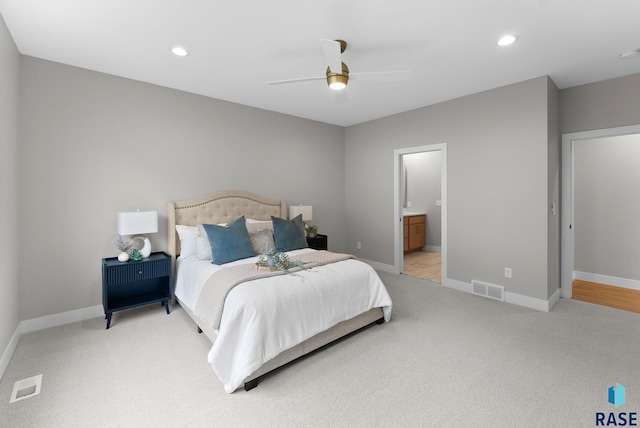 carpeted bedroom with connected bathroom and ceiling fan