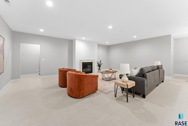 living room featuring a large fireplace and light colored carpet