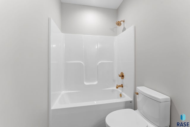 bathroom with washtub / shower combination and toilet