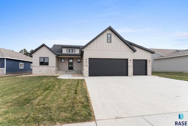 modern inspired farmhouse featuring a front lawn and a garage