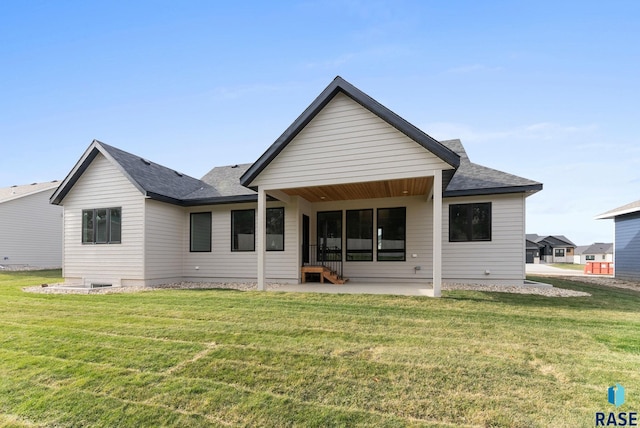 back of property featuring a patio and a lawn