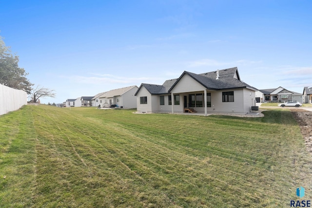 rear view of property featuring a yard