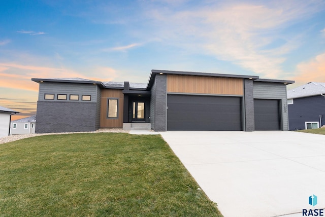 contemporary home with a yard and a garage