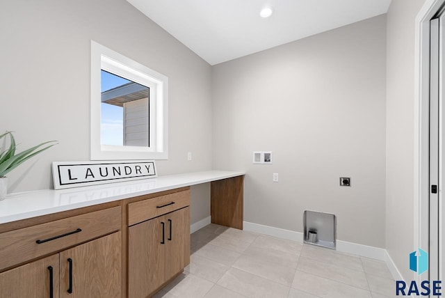 clothes washing area with cabinets, washer hookup, light tile patterned floors, and electric dryer hookup