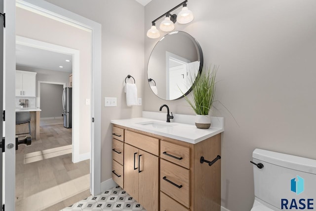 bathroom featuring vanity and toilet