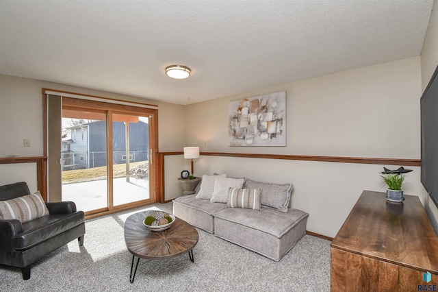 carpeted living room featuring a textured ceiling