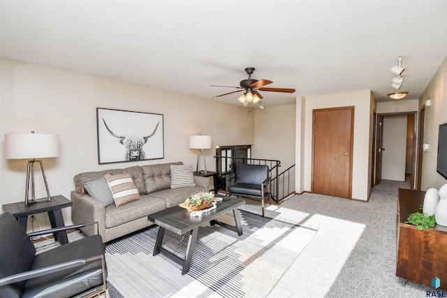 carpeted living room featuring ceiling fan