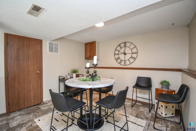 dining room with a textured ceiling