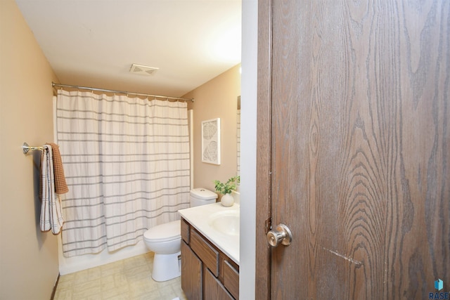 bathroom featuring vanity, curtained shower, and toilet