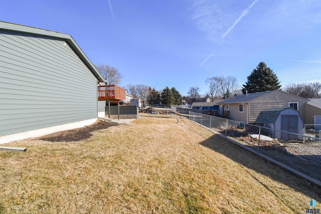 view of yard with a storage shed and a wooden deck