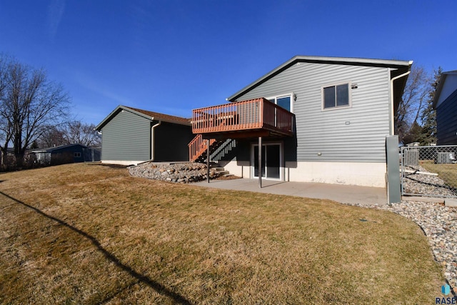 rear view of property featuring a yard, a patio, and a deck