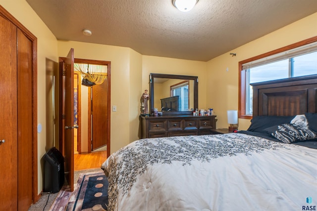 bedroom featuring a textured ceiling and a closet