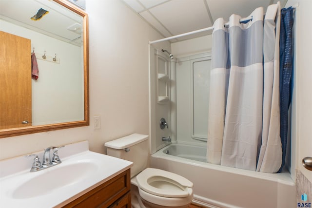 full bathroom featuring shower / tub combo, vanity, toilet, and a drop ceiling