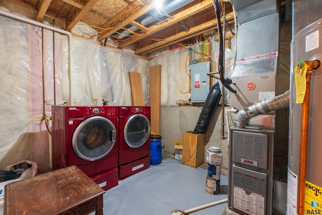 clothes washing area with electric panel, separate washer and dryer, and heating unit