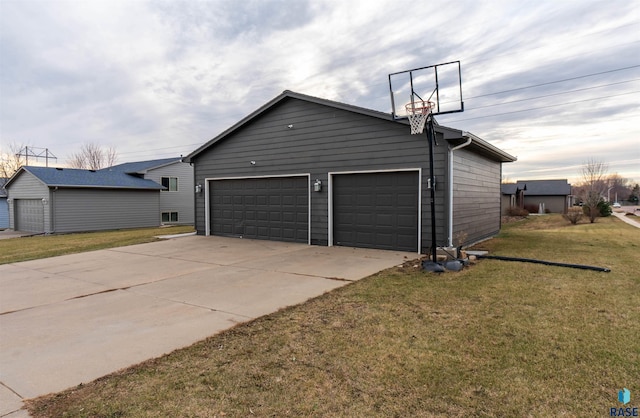 exterior space featuring a garage, an outdoor structure, and a yard