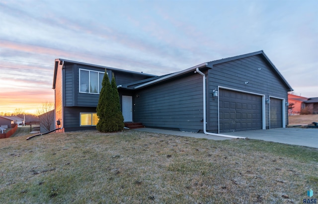 view of front facade with a yard and a garage