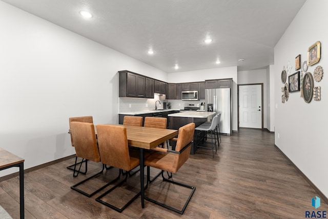 dining space with dark wood-type flooring and sink