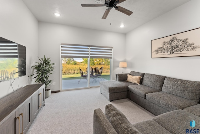 living room featuring ceiling fan and light colored carpet