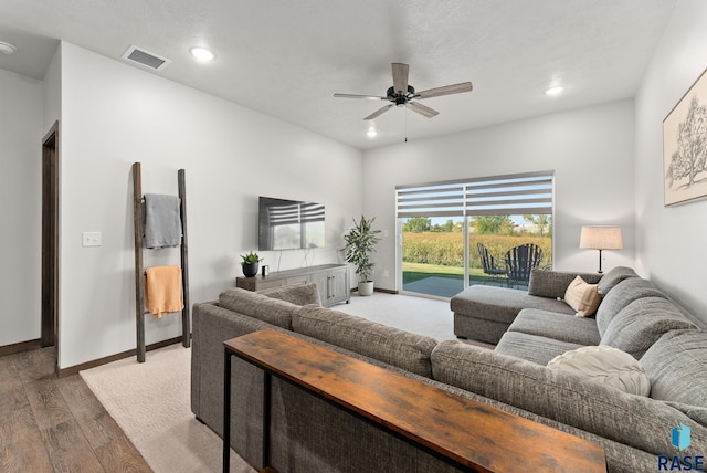 living room featuring hardwood / wood-style flooring and ceiling fan