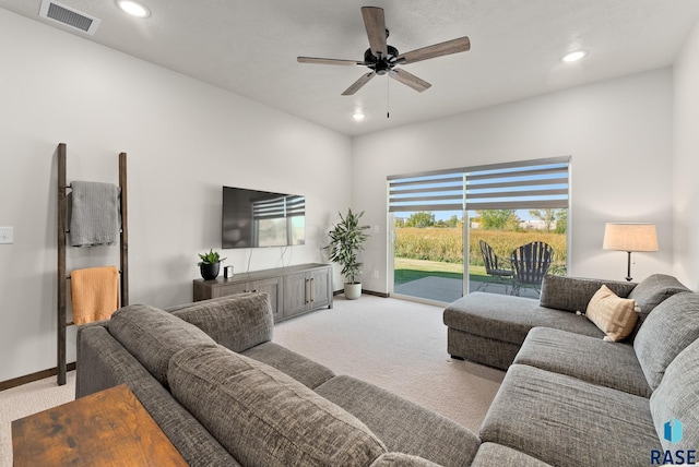 living room featuring ceiling fan and light colored carpet