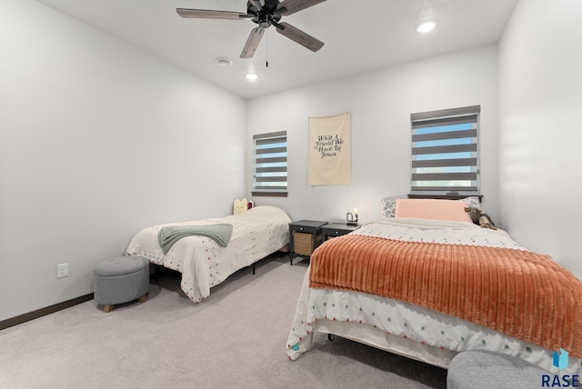 carpeted bedroom with multiple windows and ceiling fan