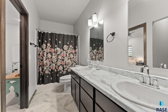 bathroom featuring vanity, ceiling fan, and toilet