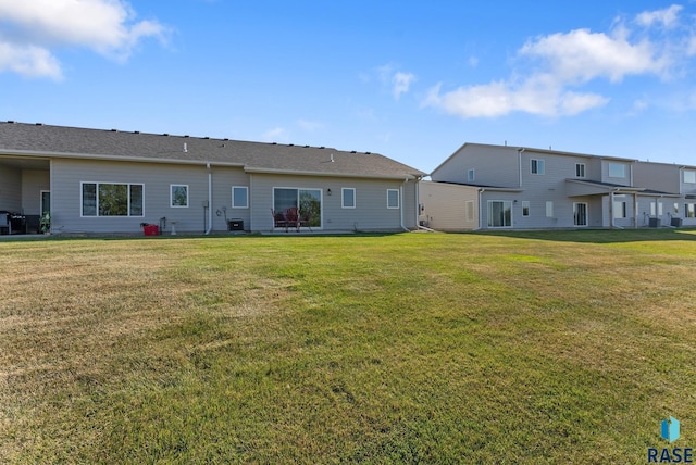 back of property featuring a lawn