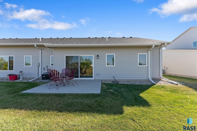 back of property featuring central air condition unit, a patio area, and a yard