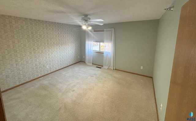 unfurnished room featuring carpet flooring and ceiling fan