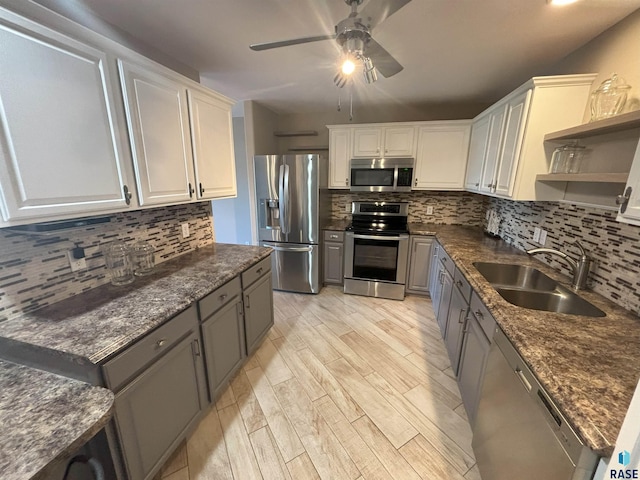 kitchen featuring stainless steel appliances, ceiling fan, sink, light hardwood / wood-style flooring, and white cabinetry