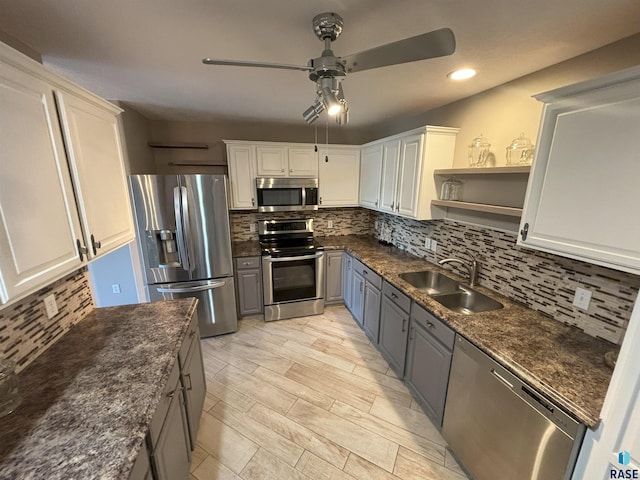 kitchen featuring white cabinets, sink, ceiling fan, gray cabinets, and stainless steel appliances