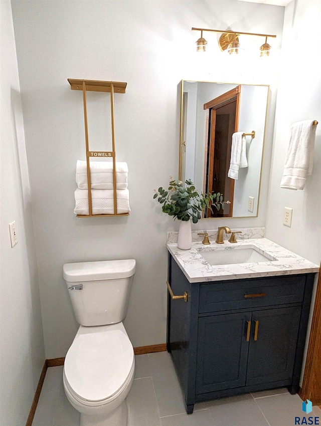 bathroom featuring tile patterned floors, vanity, and toilet