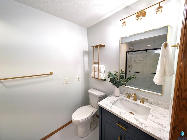 bathroom with vanity, a textured ceiling, toilet, and an enclosed shower