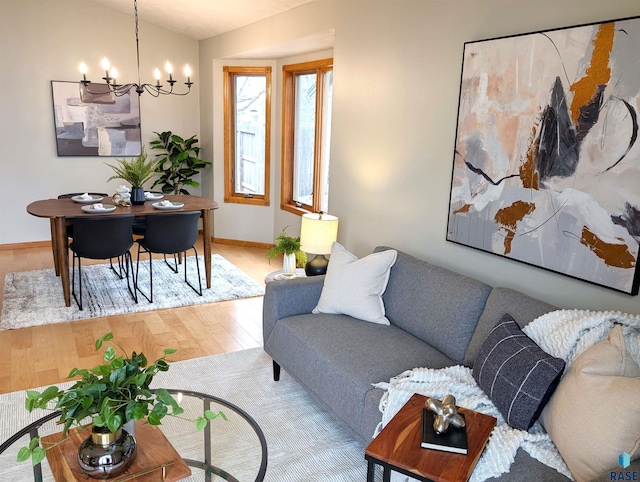 living room with wood-type flooring and a notable chandelier