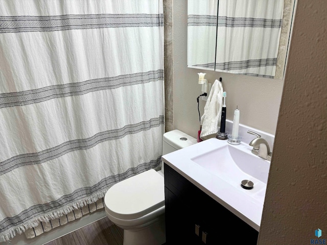 bathroom featuring hardwood / wood-style flooring, vanity, and toilet