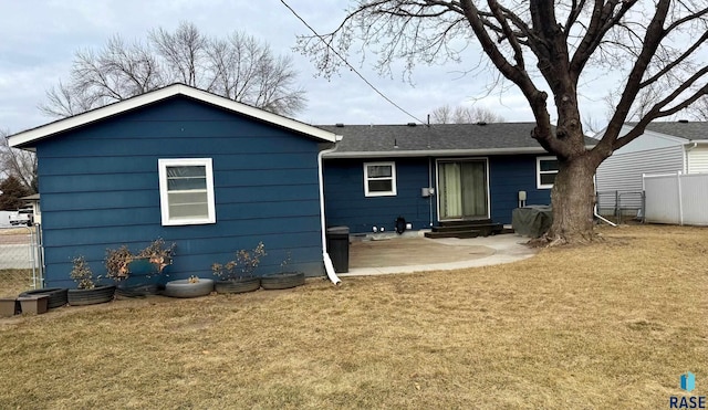 rear view of house with a patio area and a lawn