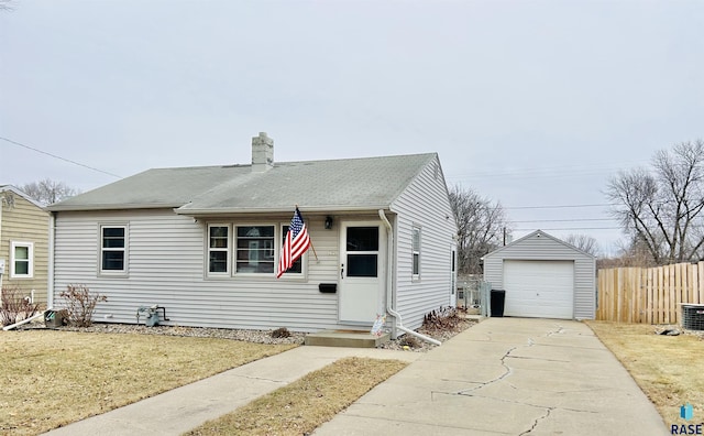 view of front of property with an outbuilding, a garage, and a front lawn