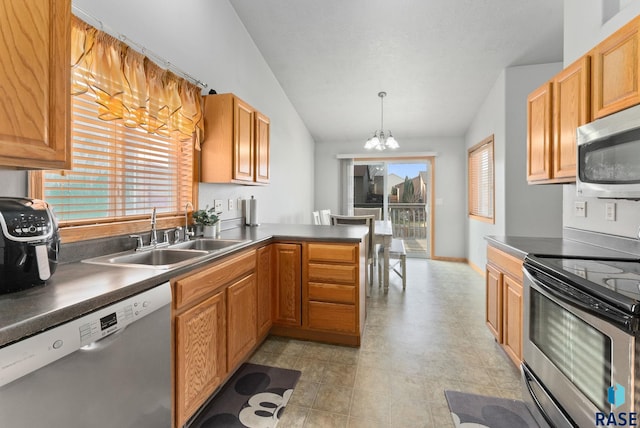 kitchen featuring pendant lighting, lofted ceiling, appliances with stainless steel finishes, kitchen peninsula, and a chandelier