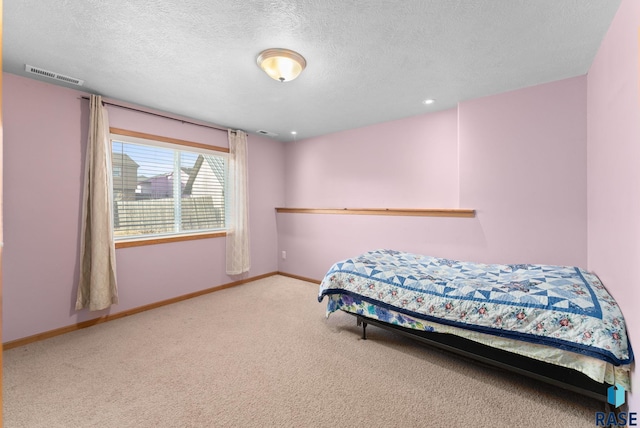 carpeted bedroom with a textured ceiling